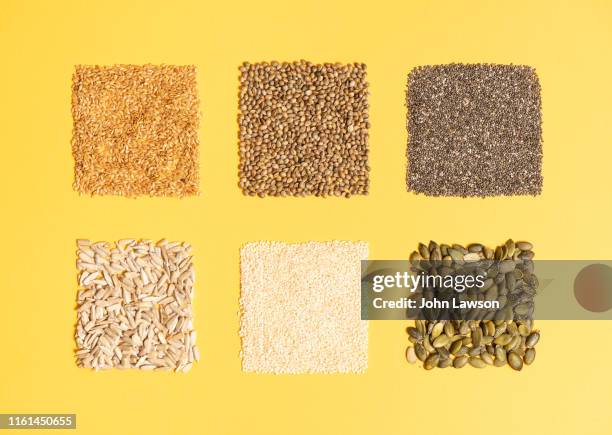 seeds on a plain yellow background - fibre food stockfoto's en -beelden