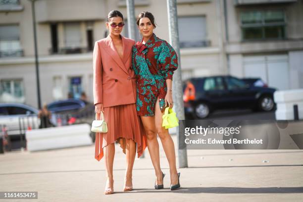 Bruna Marquezine wears sunglasses, earrings, a rust-color double-breasted jacket, a rust -color pleated asymmetric skirt, a pistachio-green bag,...