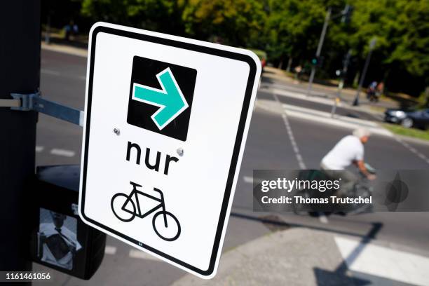 Green arrow for cyclists is mounted next to a traffic light on August 13, 2019 in Berlin, Germany.