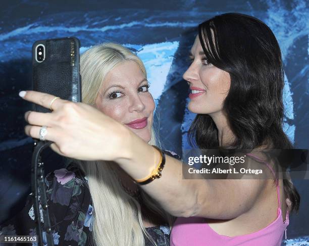 Erin Ziering takes a selfie with Tori Spelling at the Premiere Of SyFy's "Zombie Tidal Wave" held at The Garland Hotel on August 12, 2019 in North...