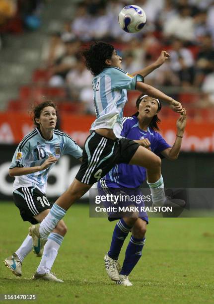 Gabriela Chavez of Argentina heads the ball as teamate Emilia Mendieta and Japanese player Yuki Nagasato looks on during their 2007 FIFA Women's...