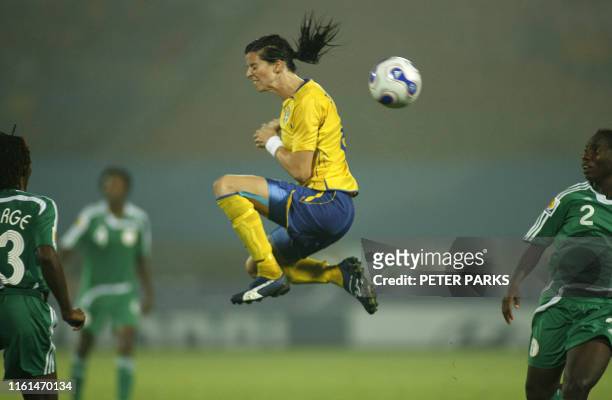Sweden's Charlotta Schelin misses a high ball as Nigeria's Efioanwan Ekpo looks on during their group B match in the Women's World Cup 2007 in...
