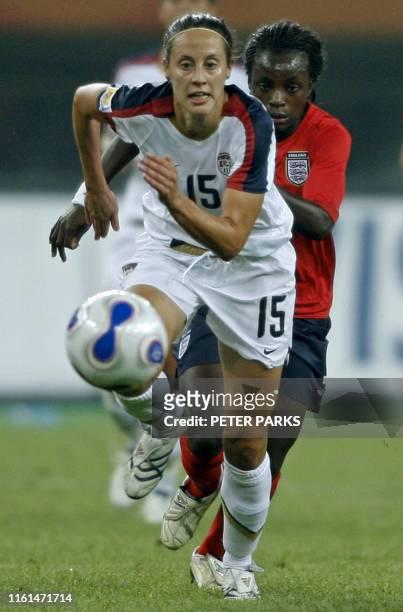 Eniola Aluko of England and Kate Markgraf of the USA fight for the ball during their quarterfinal match of the FIFA Women's World Cup football...