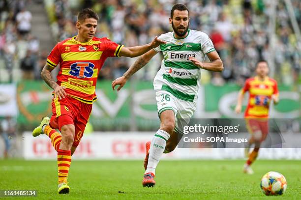 Patryk Klimala from Jagiellonia Bialystok and Blazej Augustyn from Lechia Gdansk are seen in action during the PKO Ekstraklasa League match between...