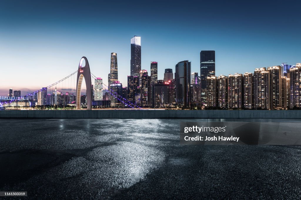 Empty parking lot with cityscape background