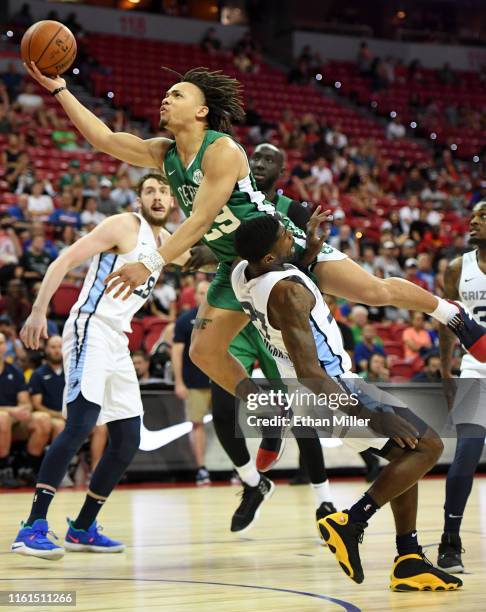 Carsen Edwards of the Boston Celtics is fouled as he drives against Shaq Buchanan of the Memphis Grizzlies during the 2019 NBA Summer League at the...