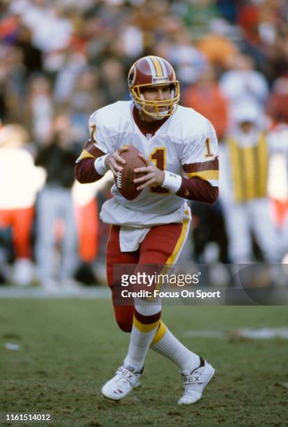 Mark Rypien of the Washington Redskins drops back to pass during an NFL football game circa 1993 at RFK Stadium in Washington, D.C.. Rypien played...