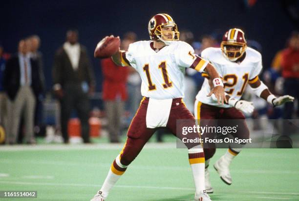 Mark Rypien of the Washington Redskins drops back to pass against the New York Giants during an NFL football game October 27, 1991 at Giants Stadium...