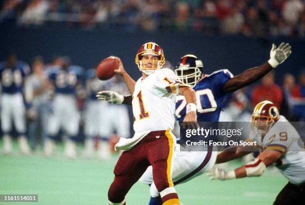 Mark Rypien of the Washington Redskins drops back to pass against the New York Giants during an NFL football game October 27, 1991 at Giants Stadium...