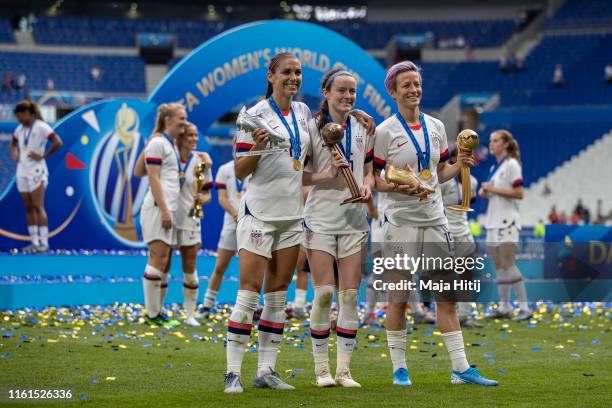 Megan Rapinoe of the USA celebrates with the Golden Ball award, Alex Morgan of the USA celebrates with silver boot, teammate Rose Lavelle celebrates...
