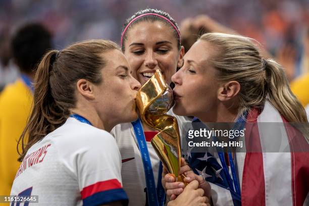 Kelley O'hara, Alex Morgan and Allie Long of the USA celebrate with the FIFA Women's World Cup Trophy following the 2019 FIFA Women's World Cup...