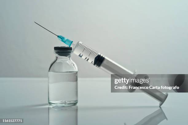 syringes and injectable medications - injection stock-fotos und bilder