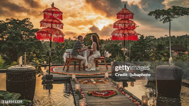 feeling closer than ever - asian couple dinner stock pictures, royalty-free photos & images