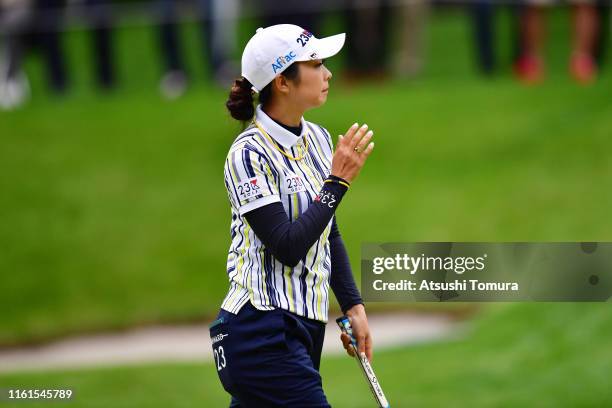 Erika Kikuchi of Japan applauds fans after holing out with the birdie on the 18th green during the second round of the Nippon Ham Ladies Classic at...