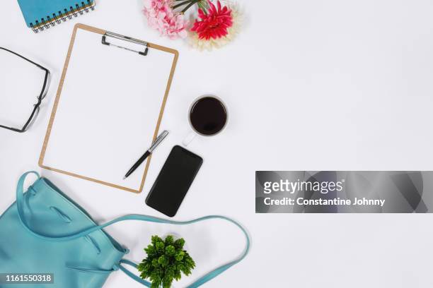 women's handbag and clipboard on white desk - blue purse stock pictures, royalty-free photos & images