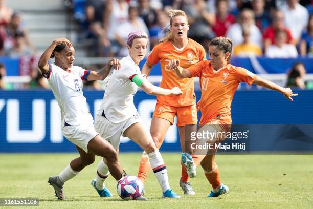 Crystal Dunn , Megan Rapinoe of the USA and Desiree van Lunteren and Danielle van de Donk of the Netherlands battle for possession during the 2019...