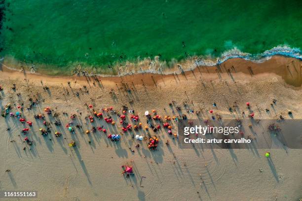 crowded beach from above - luanda bay stock pictures, royalty-free photos & images