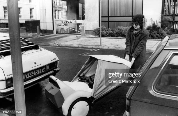 Jenny finds a convenient parking space for her Sinclair C5, between two cars. 19th January 1985.