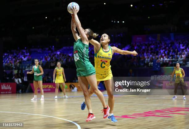 Lisa McCaffrey of Northern Ireland battles with Liz Watson of Australia during the preliminaries stage one match between Australia and Northern...