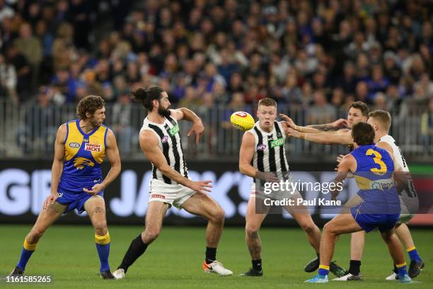 John Noble and Isaac Quaynor of the Magpies sing the club song with team mates after winning the round 17 AFL match between the West Coast Eagles and...