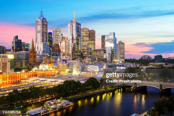 skyscrapers of melbourne central business district with prince bridge and yarra river at night in melbourne, victoria, australia. - melbourne aerial view stock pictures, royalty-free photos & images