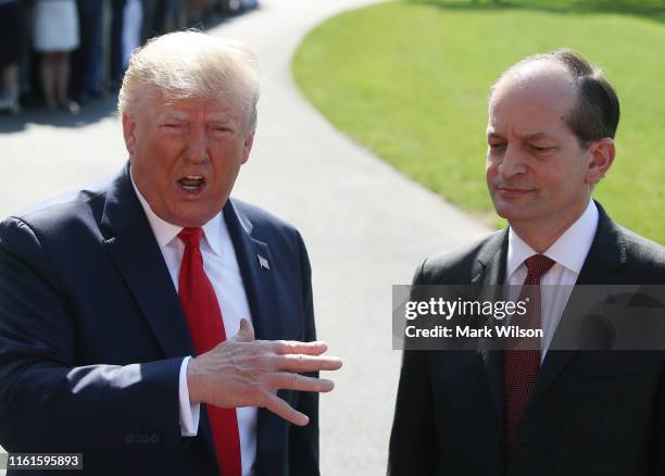 President Donald Trump stands with Labor Secretary Alex Acosta, who announced his resignation, while talking to the media at the White House on July...