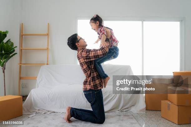 father playing with his daughter at new home. - petite teen girl stock-fotos und bilder