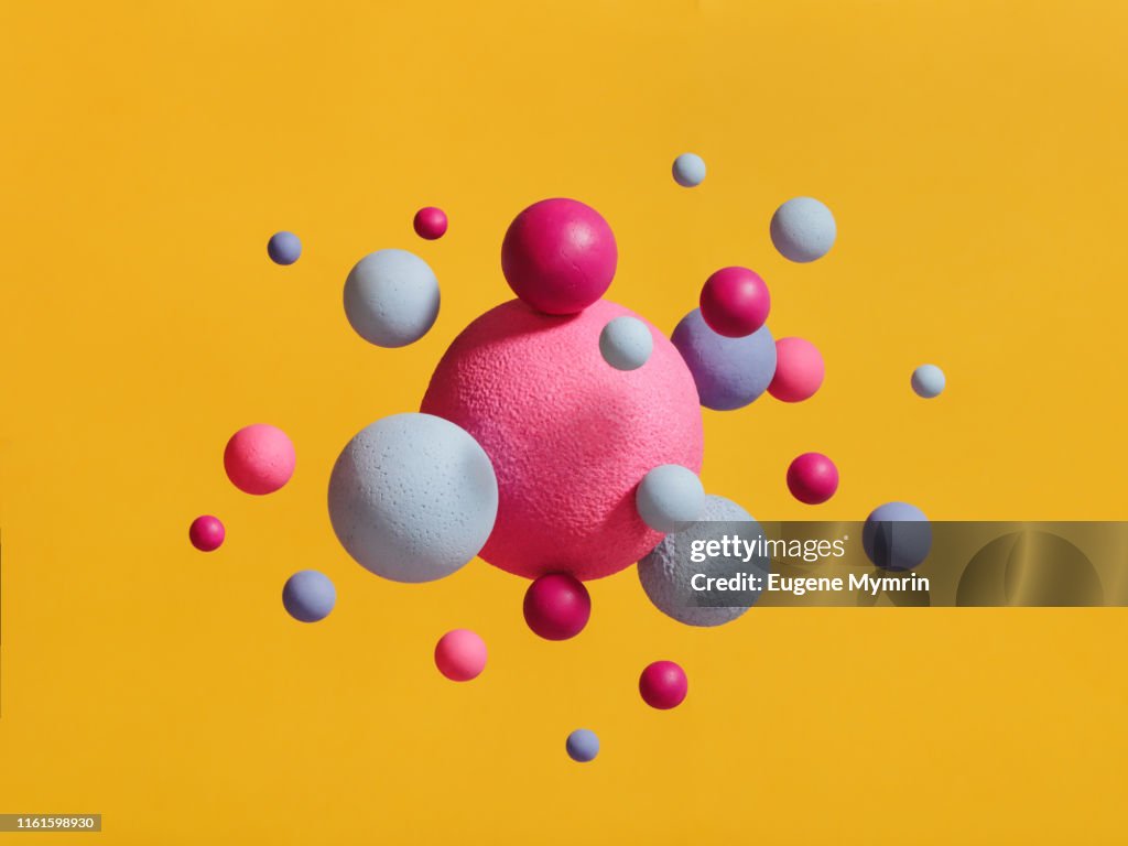 Abstract multi-colored spheres on yellow background