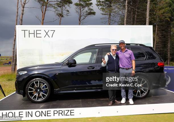 Keith Pelley, Chief Executive of the European Tour, poses with Bradley Dredge of Wales as he hands over the keys to a BMW X7 after a hole-in-one on...