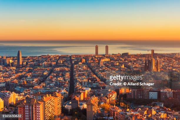 high angle view over barcelona spain at sunset - barcelona spanien stock-fotos und bilder