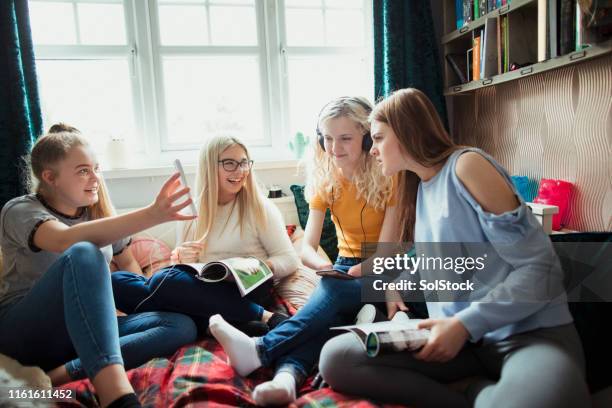 showing her friends her phone - amputee girl stock pictures, royalty-free photos & images