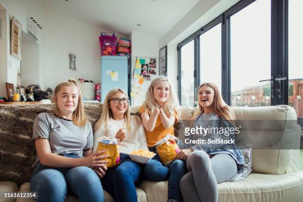 teenage girls watching tv - amputee girl stock pictures, royalty-free photos & images