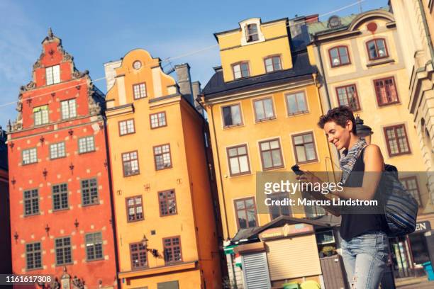 female tourist visiting stortorget in stockholm - stockholm old town stock pictures, royalty-free photos & images