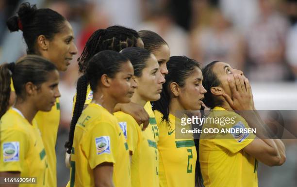 Brazil's striker Marta and her teammates react during penalty kicks shot by the US during the quarter-final match of the FIFA women's football World...