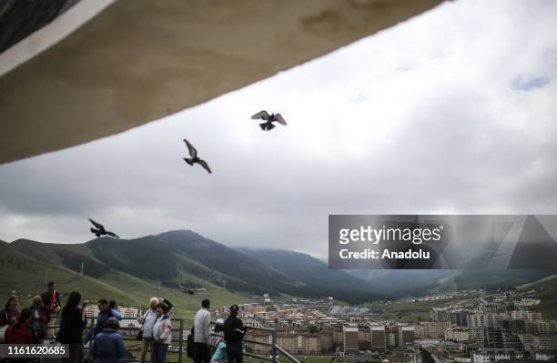 People enjoy the view from Zaisan Memorial in the Mongolian capital Ulaanbaatar on August 14, 2019. Mongolia receives many tourists from all across...