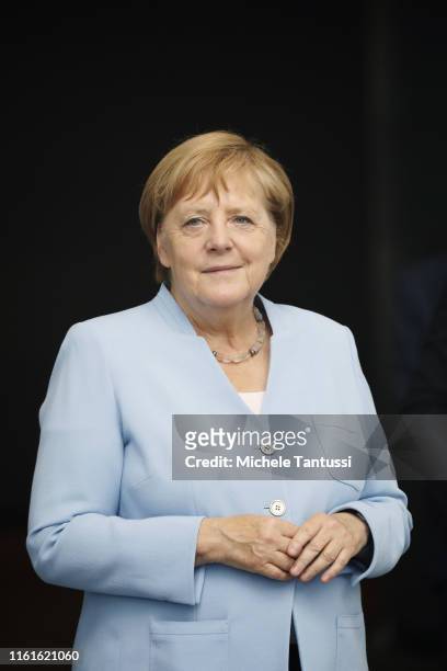 German Chancellor Angela Merkel is seen through a glass window as she awaits the arrival of Lithuanian President Gitanas Nauseda at the Chancellery...