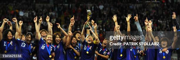 Japan's midfielder Homare Sawa celebrates with the trophy and teammates after the FIFA Women's Football World Cup final match Japan vs USA on July...