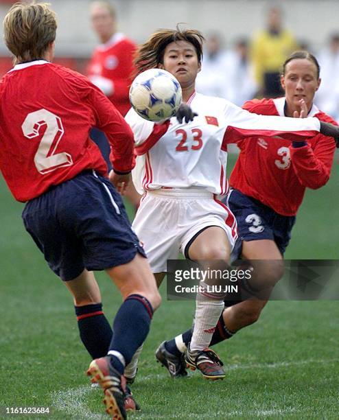 Chinese player Han Duan tires to shoot as Brit Sandaune and Ane Stangland defend during their match at the Four Nations Women Soccer Championship in...