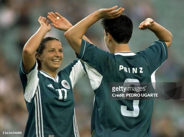 Germans Inka Gring and Birgit Prinz celebrate after their 2-0 victory over Brazil in the women's soccer game for the bronze at the Sydney Olympic...