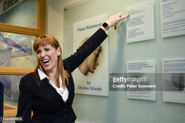 Angela Rayner, Shadow Secretary for Education, gestures towards a mission statement which reads 'Saint Angela is our inspiration' during visit to...