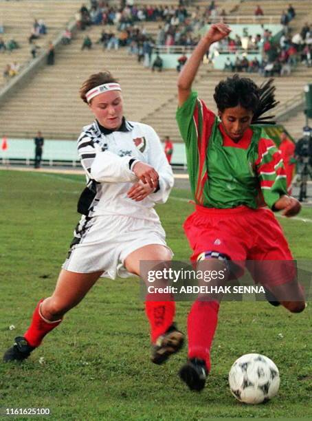 Moroccan women soccer team striker Khadija Rezag fights for the ball win Sweden's Jenny Wiras during their game11 December in Rabat. Morocco won 4 to...