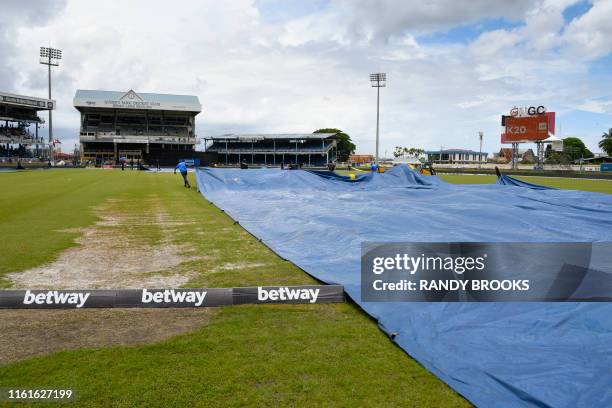 Ground staff bring on the covers during the 3rd ODI match between West Indies and India at Queens Park Oval, Port of Spain, Trinidad and Tobago, on...