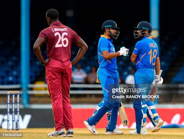 Shreyas Iyer and Virat Kohli of India celebrate 50 partnership as Carlos Brathwaite of West Indies expresses disappointment during the 3rd ODI match...