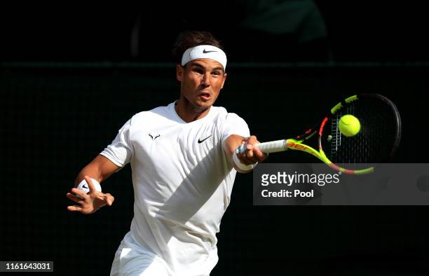 Rafael Nadal of Spain plays a forehand in his Men's Singles semi-final match against Roger Federer of Switzerland during Day eleven of The...