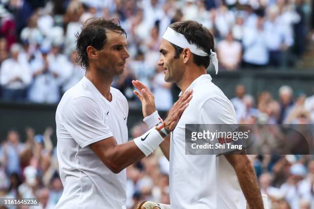 Roger Federer of Switzerland greets Rafael Nadal of Spain after their Men's Singles semi-final match during Day eleven of The Championships -...