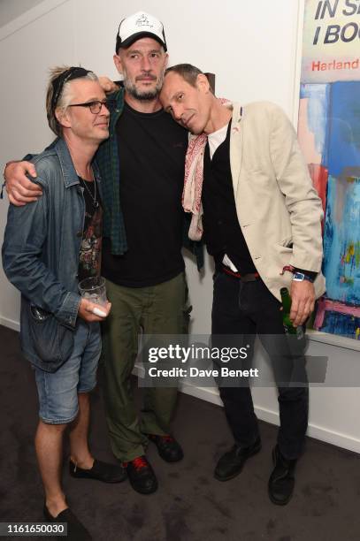 Guest, Jake Chapman and Marlon Richards attends the Teen Cancer America Suite at Bob Dylan and Neil Young in Hyde Park on July 12, 2019 in London,...