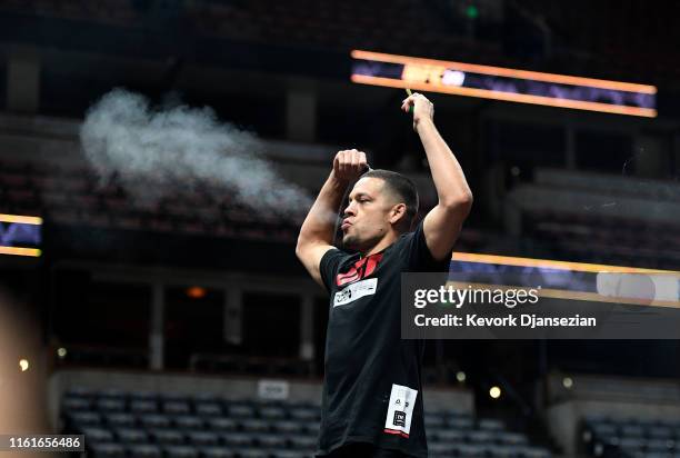 Former UFC lightweight title challenger Nate Diaz smokes during an open workout for fans and media at Honda Center on August 14, 2019 in Anaheim,...