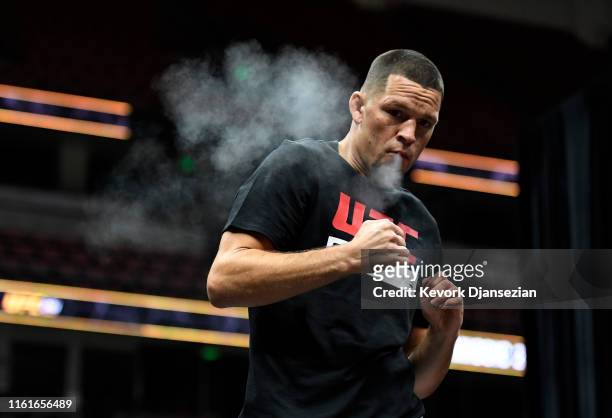 Former UFC lightweight title challenger Nate Diaz smokes during an open workout for fans and media at Honda Center on August 14, 2019 in Anaheim,...