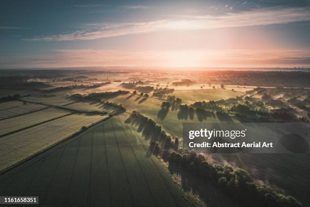 early morning views across the english countryside shot by drone, england, united kingdom - drone aerial stock-fotos und bilder