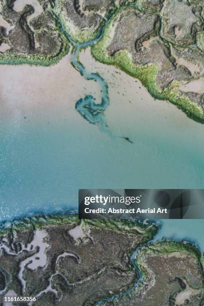 marshland patterns from above, essex, england, united kingdom - nun river estuary stock-fotos und bilder